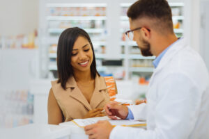 Pharmacist assisting patient with questions about their prescription. 